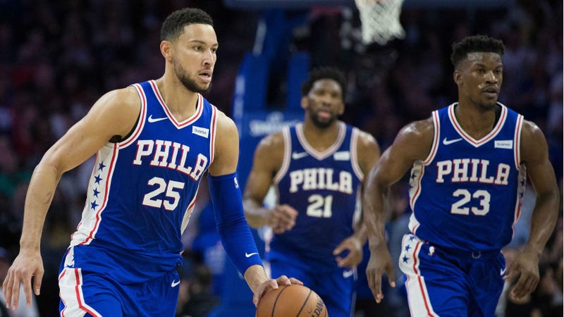 Philadelphia 76ers guard Ben Simmons (25) dribbles up court in front of guard Jimmy Butler (23) and center Joel Embiid (21) during the second quarter against the Boston Celtics at Wells Fargo Center.