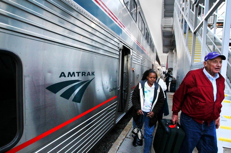 Passengers step off of an Amtrak train.