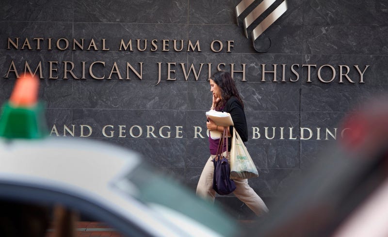A passerby walks in front of the American Jewish History Museum.