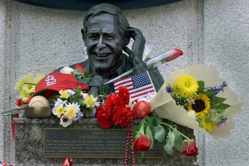 flowers and gifts adorn a bronze bust of the late Jack Buck, an announcer for the St. Louis Cardinals