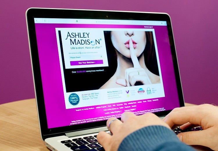 PICTURE POSED BY MODEL A man wearing a wedding ring looks at the Ashley Madison website, as a second wave of personal data alleged to have come from the adultery site has been published online by the site's hackers.