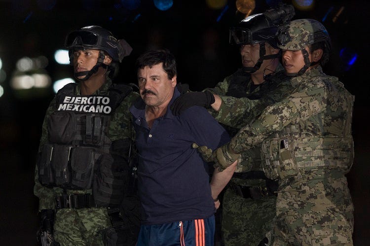 BEIJING, Jan. 10, 2016 (Xinhua) -- Soldiers escort Joaquin Guzman Loera, alias "El Chapo", upon his arrival to the hangar of the Attorney General's Office, in Mexico City, capital of Mexico, on Jan. 8, 2016. After an early morning raid in northwestern Mex