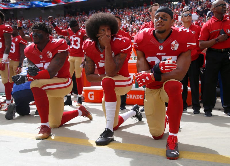 From left: The San Francisco 49ers' Eli Harold (58), Colin Kaepernick (7) and Eric Reid (35) kneel during the national anthem before their a game against the Dallas Cowboys on Oct. 2, 2016.