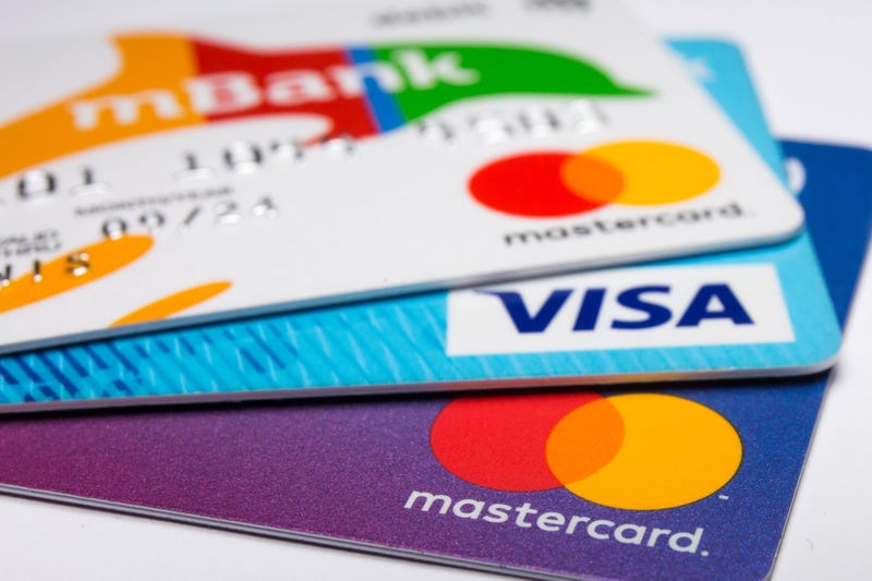 n this photo illustration a Visa credit card and Mastercard debit cards are seen displayed.