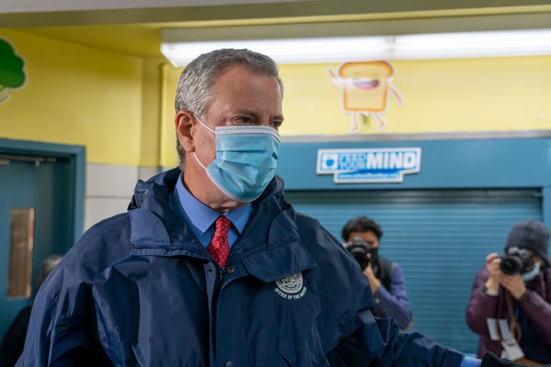 Mayor Bill de Blasio greets staff workers at a polling site in Manhattan.