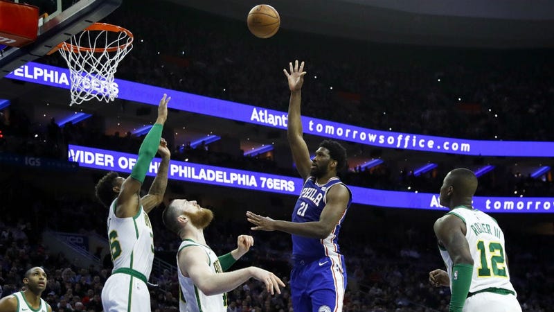 Philadelphia 76ers' Joel Embiid (21) shoots as Boston Celtics' Terry Rozier, from right, Aron Baynes, Marcus Smart and Al Horford watch during the first half of an NBA basketball game, Wednesday, March 20, 2019, in Philadelphia.