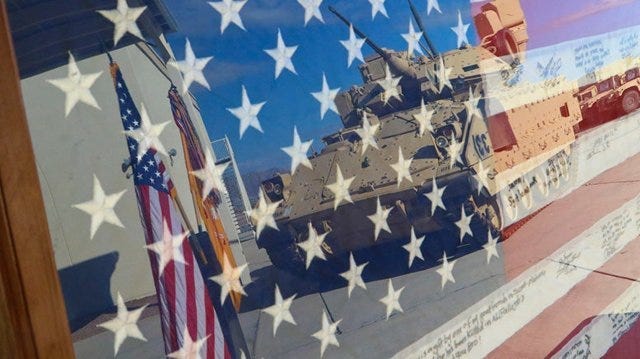 An encased flag is displayed during a ceremony held Sept. 11