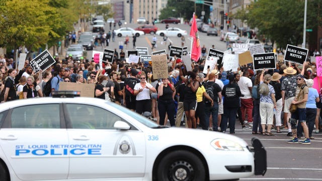 Police block the streets for protesters during a peaceful protest outside of St. Louis Metropolitian Police Headquarters in St. Louis on September 17, 2017.