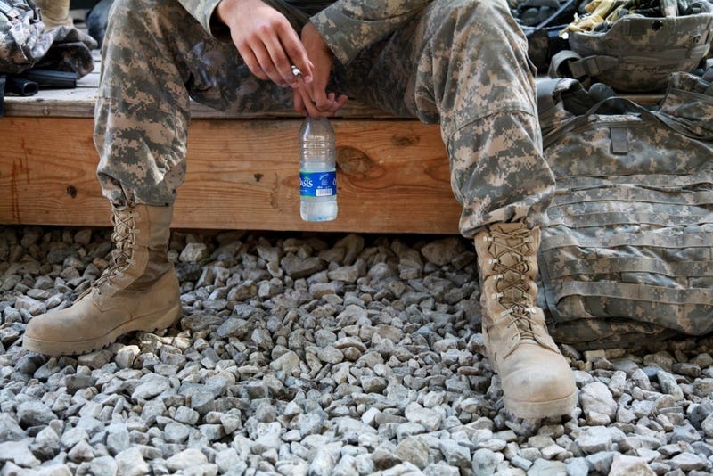 U.S. Army Spc. William Lang, 25, from Dallas, Texas, assigned to the Kapisa-Parwan Provincial Reconstruction Team, smokes a cigarette while waiting to go out on mission from Bagram Airfield, Afghanistan on Aug. 9.
