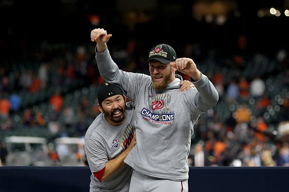 Stephen Strasburg celebrates the World Series with teammate Kurt Suzuki.