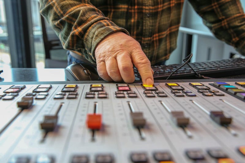 Anchor Brandon Brooks operates the new control board in the air studios.