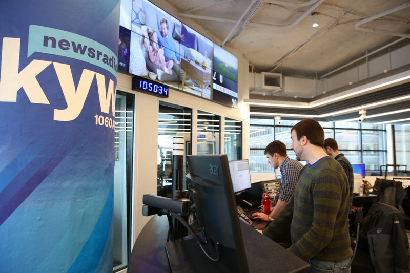 News production assistant Phillip Casey, editor Tim McLaughlin, and writer Conner Barkon man the new KYW Newsradio editor's desk at 2400 Market.