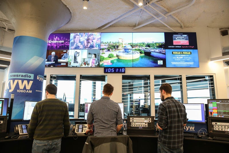 News production assistant Phillip Casey, editor Tim McLaughlin, and writer Conner Barkon man the new KYW Newsradio editor's desk at 2400 Market.