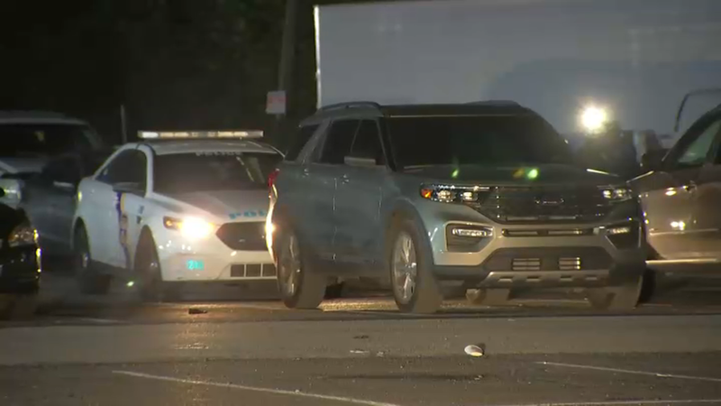 police car behind Ford Explorer in parking lot