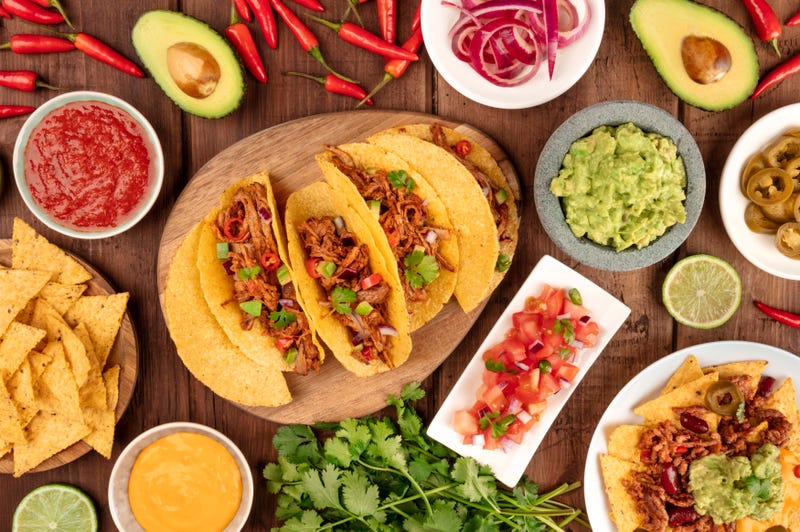 A plate of tacos and condiments
