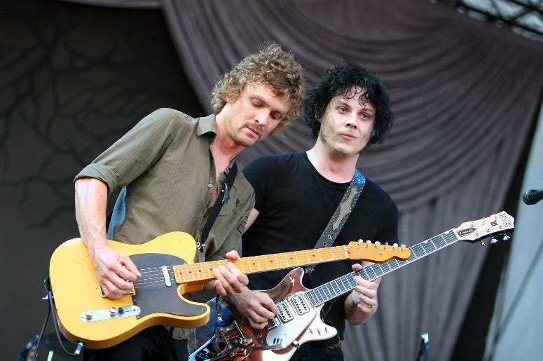 Singer/guitarist Brendan Benson (L) and singer/guitarist Jack White of The Raconteurs perform onstage at the 2008 Lollapalooza