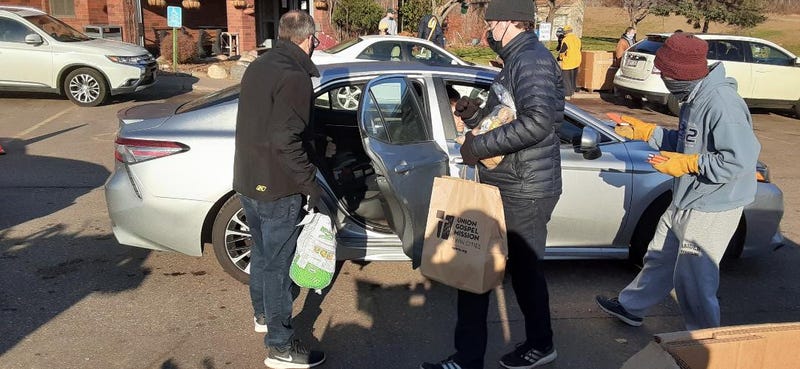 Union Gospel Mission volunteers load up car with Thanksgiving food in annual giveaway
