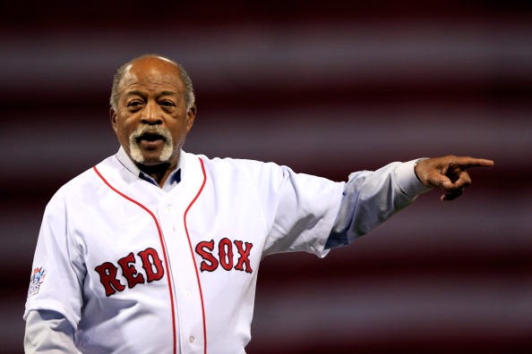 Red Sox legend Luis Tiant throws out the first pitch at Fenway Park.