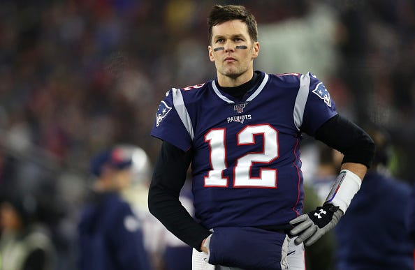 Tom Brady looks on from the sidelines as the Patriots are eliminated from the playoffs.
