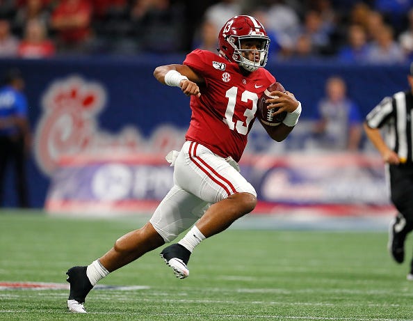 Tua Tagovailoa runs for a first down for Alabama.