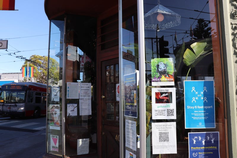 Signs in the window of the Twin Peaks Tavern in San Francisco asking for donations and reminding residents to stay safe