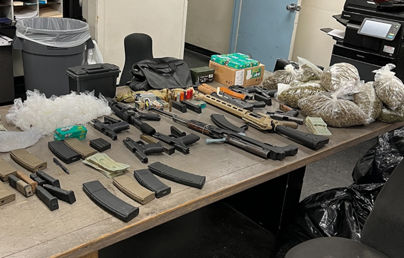 Officers recovered thousands of dollars in drugs and firearms in the bust on Wednesday.