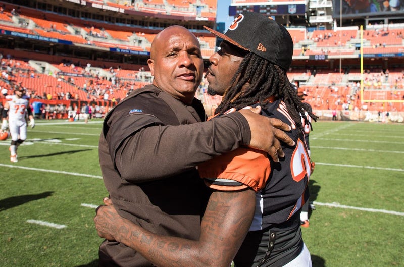 Cleveland Browns head coach Hue Jackson hugs Cincinnati Bengals cornerback Adam Jones (24) after the game at FirstEnergy Stadium.
