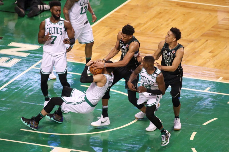 Jayson Tatum battles Giannis Antetokounmpo for the ball