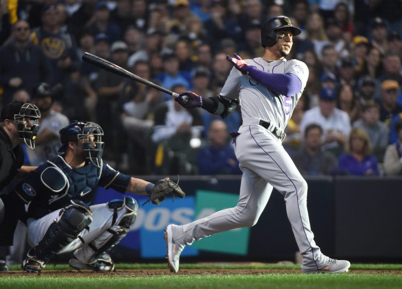Oct 4, 2018; Milwaukee, WI, USA; Colorado Rockies outfielder Carlos Gonzalez hits a triple in the fifth inning against the Milwaukee Brewers in game one of the 2018 NLDS playoff baseball series at Miller Park. Mandatory Credit: Benny Sieu-USA TODAY Sports