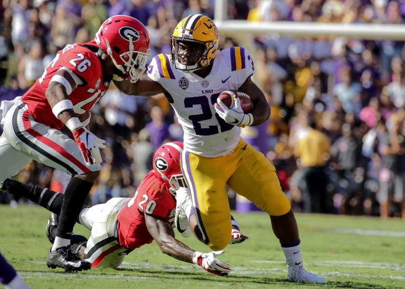 Oct 13, 2018; Baton Rouge, LA, USA; LSU Tigers running back Clyde Edwards-Helaire (22) break away from Georgia Bulldogs defensive back Tyrique McGhee (26) and defensive back J.R. Reed (20) during the second quarter at Tiger Stadium. Mandatory Credit: Deri