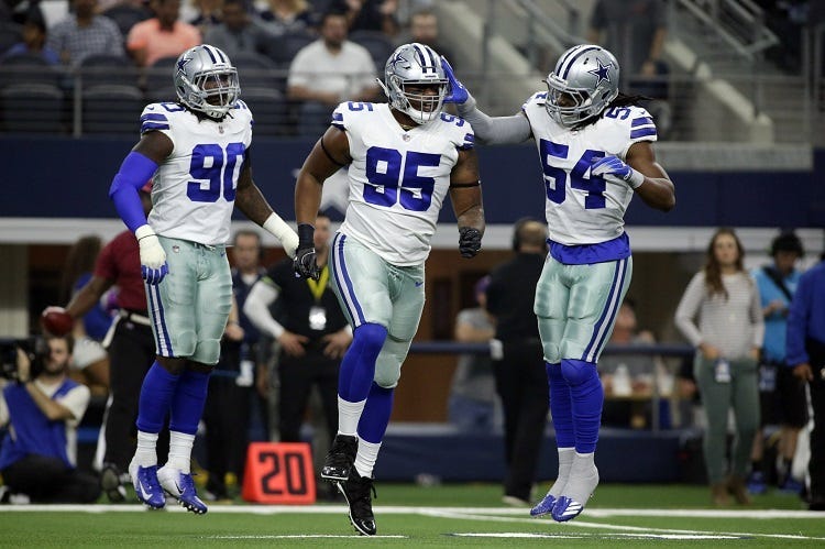 Dallas Cowboys defensive tackle David Irving (95) and linebacker Jaylon Smith (54) celebrate after a play in the first quarter against the Jacksonville Jaguars at AT&T Stadium.