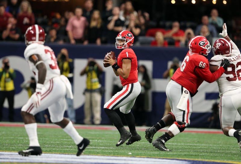 Georgia Bulldogs quarterback Justin Fields (1) looks to throw against the Alabama Crimson Tide during the second quarter in the SEC championship game at Mercedes-Benz Stadium.