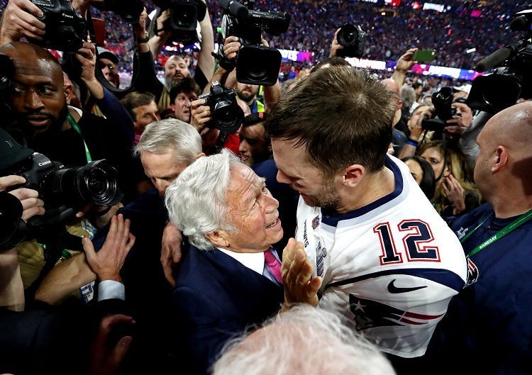 New England Patriots quarterback Tom Brady (12) celebrates with New England Patriots owner Robert Kraft after the Los Angeles Rams in Super Bowl LIII at Mercedes-Benz Stadium.
