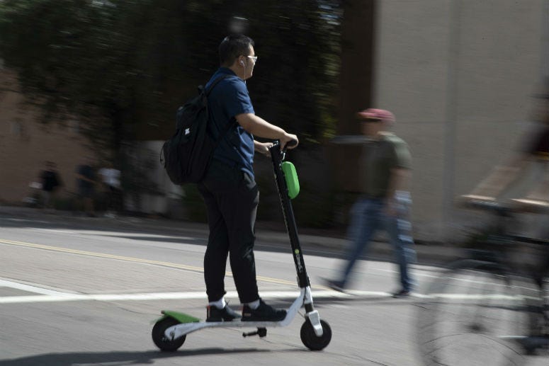 A man rides a scooter Oct. 4, 2018, in Tempe.