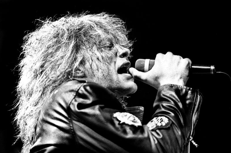 Jon Bon Jovi is performing one of Bon Jovi's hits during their \"American Brotherhood\" tour for a sold-out crowd of more than 12,000 fans at Middle Tennessee State University's Murphy Center Feb. 20, 1989. 89then02 056