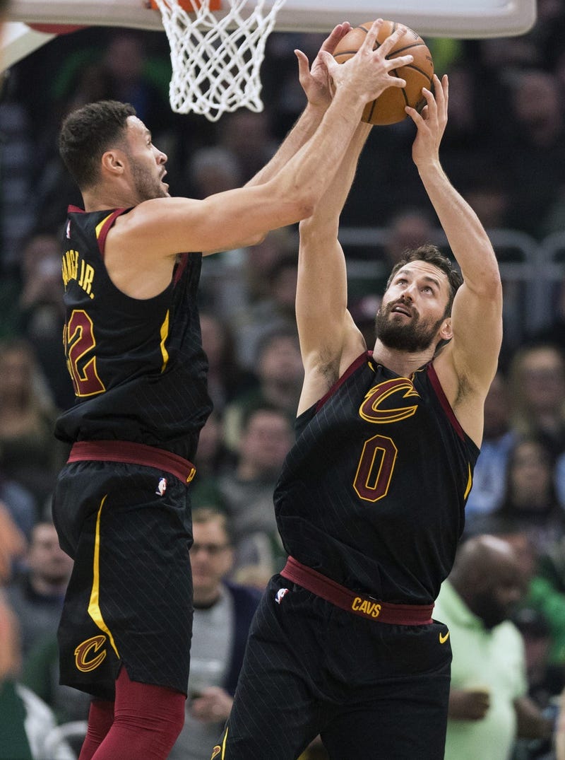 Cleveland Cavaliers forward Larry Nance Jr. (22) and forward Kevin Love (0) reach for a rebound during the first quarter against the Milwaukee Bucks at Fiserv Forum.