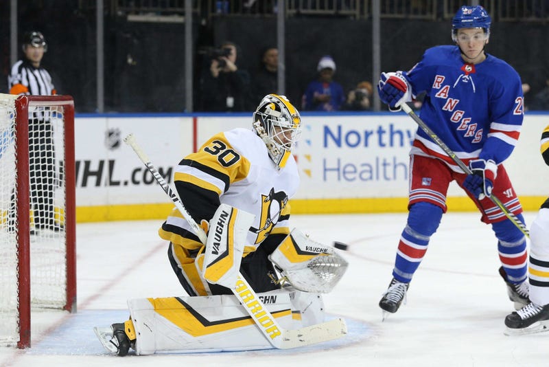 Pittsburgh Penguins goalie Matt Murray makes a save in front of New York Rangers left wing Jimmy Vesey