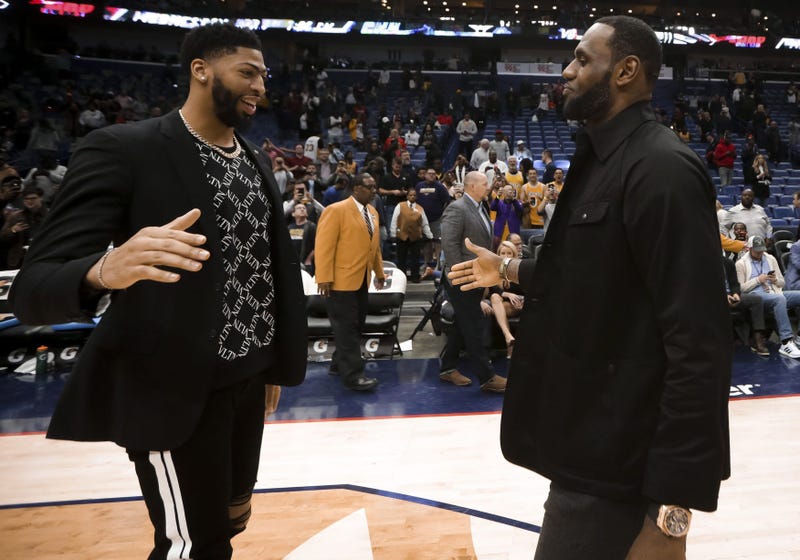 New Orleans Pelicans forward Anthony Davis meets with Los Angeles Lakers forward LeBron James following a game at the Smoothie King Center.