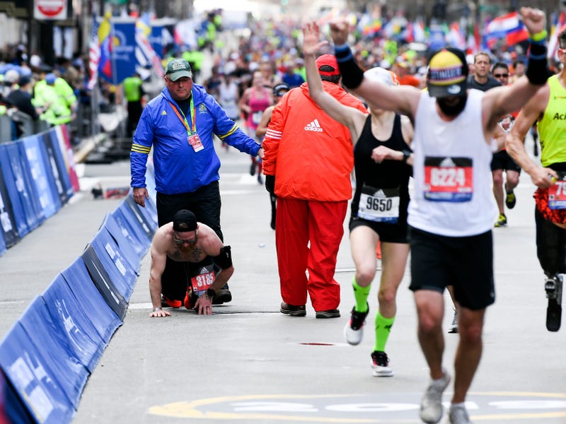 Apr 15, 2019; Boston, MA, USA; Micah Herndon crawls to the finish line of the 2019 Boston Marathon.