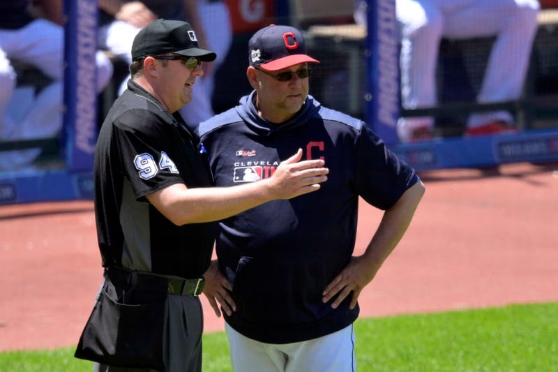 Jun 12, 2019; Cleveland, OH, USA; Home plate umpire Lance Barrett (94) talks with Cleveland Indians manager Terry Francona (77) in the fourth inning against the Cincinnati Reds at Progressive Field. Mandatory Credit: David Richard-USA TODAY Sports