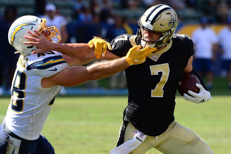 Aug 18, 2019; Carson, CA, USA; New Orleans Saints quarterback Taysom Hill (7) stiff arms Los Angeles Chargers linebacker Nick Dzubnar (48) during the fourth quarter at Dignity Health Sports Park.