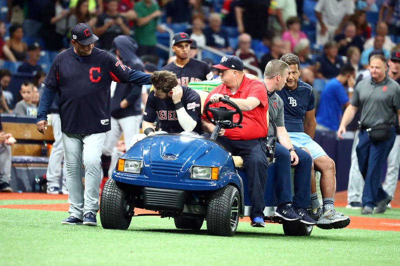 Aug 30, 2019; St. Petersburg, FL, USA; Cleveland Indians right fielder Tyler Naquin (30) is greeted by manager Terry Francona (77) while being carted off the field after an apparent injury at the end of the fifth inning against the Tampa Bay Rays at Tropi