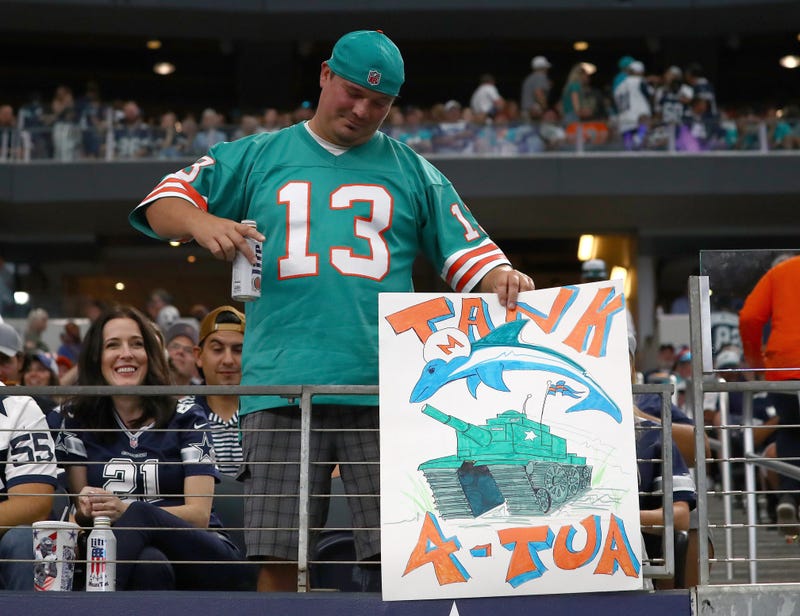 Miami Dolphins fan holds a tanking sign during the game against the Dallas Cowboys at AT&T Stadium.