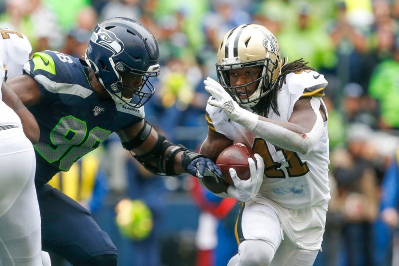 New Orleans Saints running back Alvin Kamara (41) rushes against Seattle Seahawks defensive end Rasheem Green (98) during the fourth quarter at CenturyLink Field.