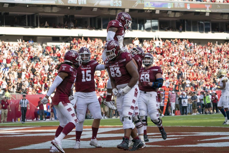 Sep 28, 2019; Philadelphia, PA, USA; Temple Owls offensive lineman Vincent Picozzi (76) lifts up Temple Owls running back Re'Mahn Davis (20) to celebrate his touchdown.