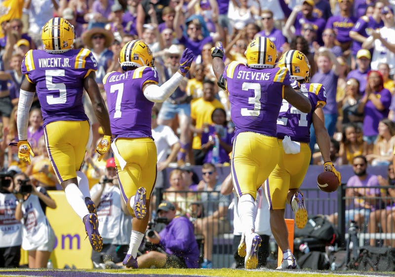 LSU Tigers cornerback Derek Stingley Jr. (24) celebrates with teammates after intercepting a pass against the Utah State Aggies during the first half at Tiger Stadium.