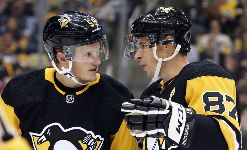 Pittsburgh Penguins center Jake Guentzel and center Sidney Crosby talk before a power play