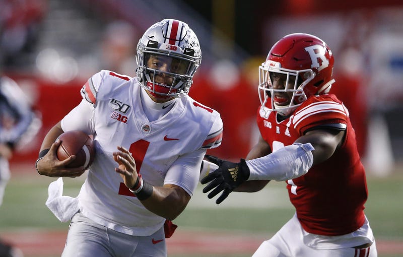 Nov 16, 2019; Piscataway, NJ, USA; Ohio State Buckeyes quarterback Justin Fields (1) runs the ball against Rutgers Scarlet Knights defensive lineman Elorm Lumor (7) during the first half at SHI Stadium. Mandatory Credit: Noah K. Murray-USA TODAY Sports