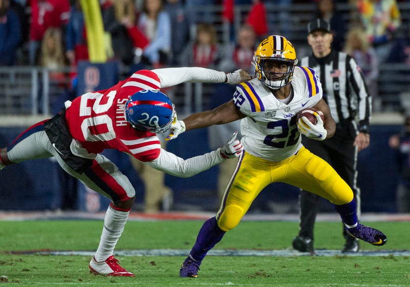 LSU Tigers running back Clyde Edwards-Helaire (22) stiff arms Mississippi Rebels defensive back Keidron Smith (20) during the first half at Vaught-Hemingway Stadium.