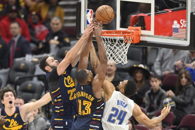 Nov 27, 2019; Cleveland, OH, USA; Cleveland Cavaliers forward Larry Nance Jr. (22) and center Tristan Thompson (13) reach for a rebound beside Orlando Magic center Khem Birch (24) in the fourth quarter at Rocket Mortgage FieldHouse. Mandatory Credit: Davi